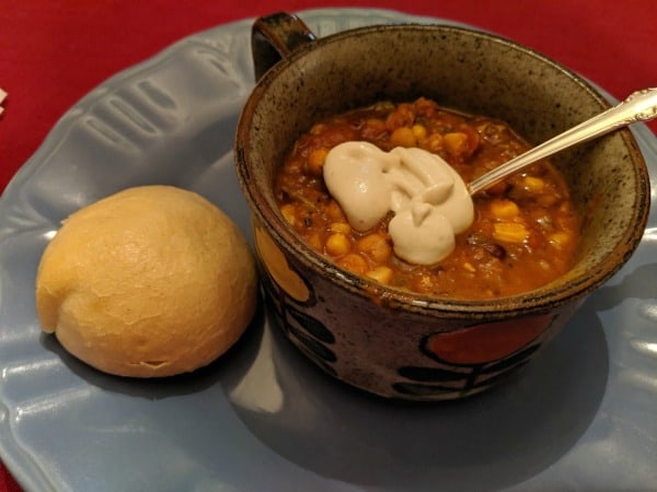 Gluten-Free Vegetarian Chili with a Dollop of Cashew Cream on top. Featured on gfe.