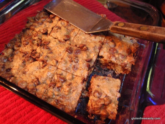 A pan of Gluten-Free Black Walnut Chocolate Chip Bars missing one bar.