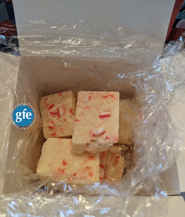 Gluten-Free Candy Cane Fudge nestled in plastic wrap in gift box.