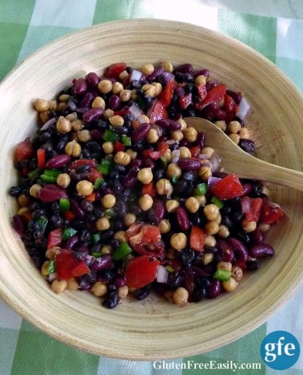 Easy Bean Salad. A fantastic medley of colors and textures. In a bamboo bowl on green plaid cotton dish towel.