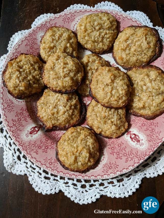 Flourless Gluten-Free Oatmeal Coconut Cookies on red and white plate on doily from above.