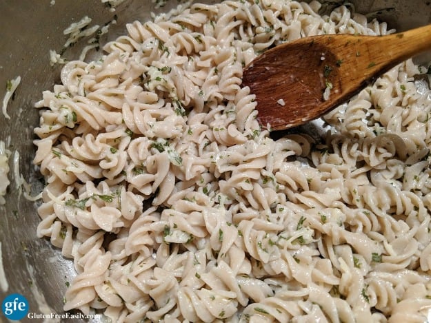 Easy Gluten-Free Parmesan Noodles with Wooden Spoon in Cooking Pot. Just a few ingredients to make this delicious dish! [from GlutenFreeEasily.com]