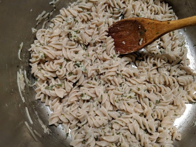 Easy Gluten-Free Parmesan Noodles with Wooden Spoon in Cooking Pot. Drain after cooking and mix all right in the still hot pot. Yummy! [from GlutenFreeEasily.com]