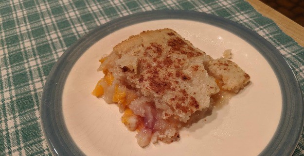 Gluten-Free Peach Cobbler serving on plate.