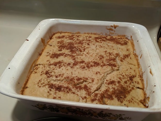 Gluten-Free Peach Cobbler warm out of the oven with crackled top.