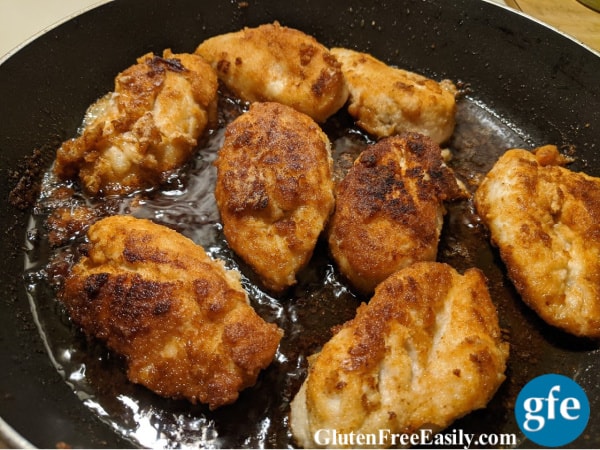 Perfect Gluten-Free Fried Chicken Breasts frying in the skillet.