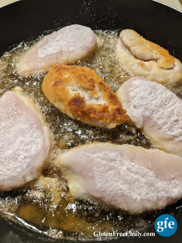 Perfect Gluten-Free Fried Chicken Breasts frying in the skillet.