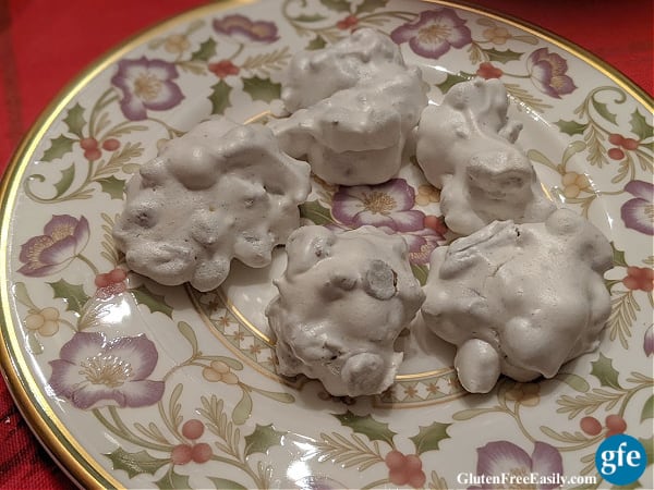 Naturally gluten-free Forgotten Cookies on a Lichfield china plate sitting on a holiday tablecloth.