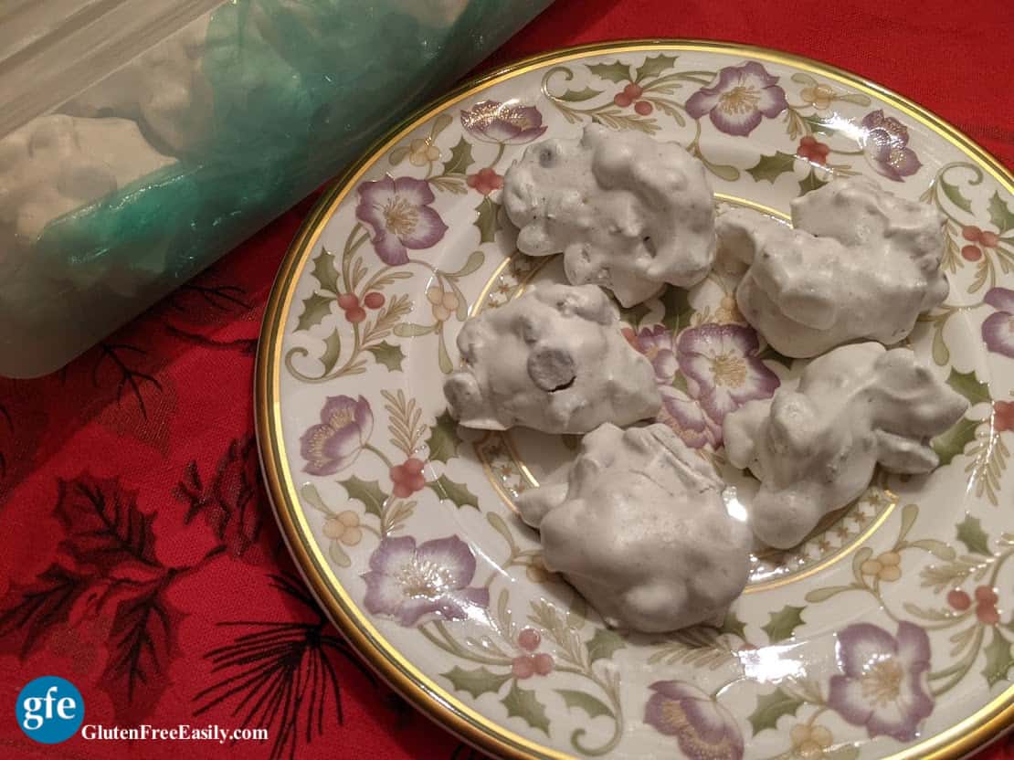 Naturally Gluten-Free Forgotten Cookies on a Lichfield china plate next to a Tupperware bread container of more cookies.