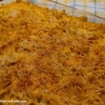 9 x 13 baking dish of Extra Cheesy Gluten-Free Macaroni and Cheese on yellow and blue plaid dish towel. Easy dairy-free option.