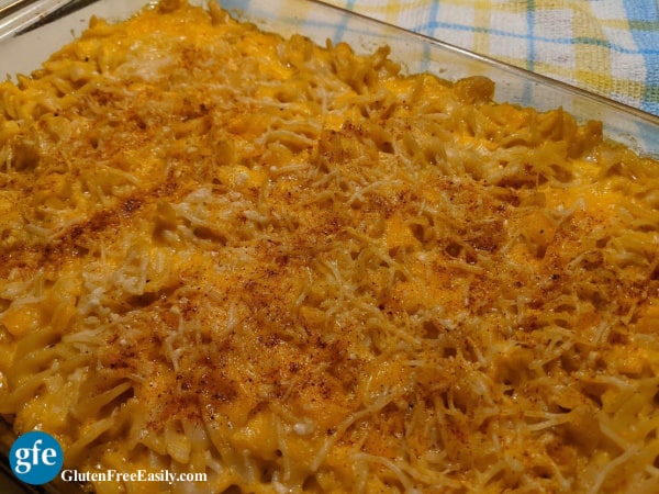 9 x 13 baking dish of Extra Cheesy Gluten-Free Macaroni and Cheese on yellow and blue plaid dish towel. Easy dairy-free option.