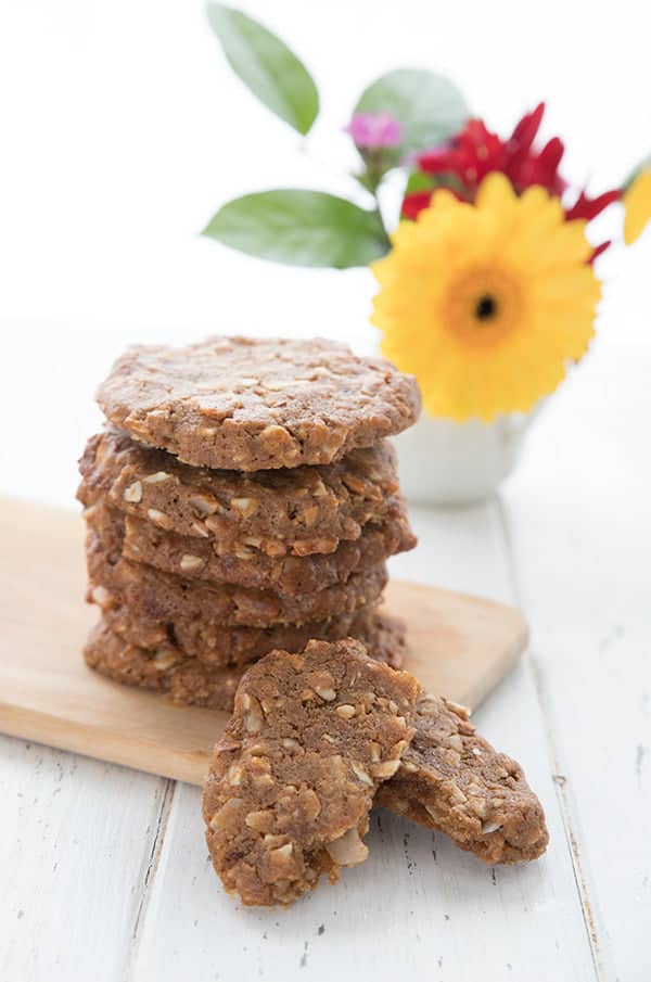 Keto Maple Oatmeal Breakfast Cookies. Stack on cutting board next to vase of flowers.