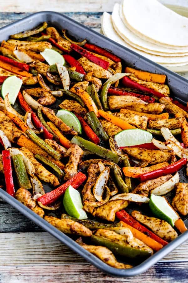 Sheet pan chicken fajitas cooked on baking sheet ready to eat. One of the recipes features on gfe for Cinco de Mayo.
