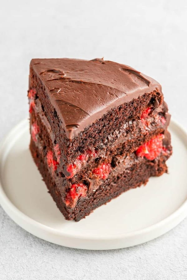 Scrumptious gluten-free raspberry cake. Three tiered chocolate cake with raspberries between layers.