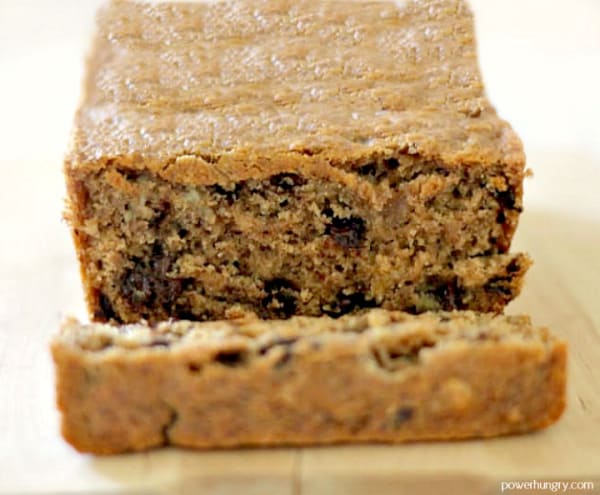 Gluten-Free Cinnamon Raisin Almond Flour Bread on a wooden cutting board with the end piece sliced and laying down.