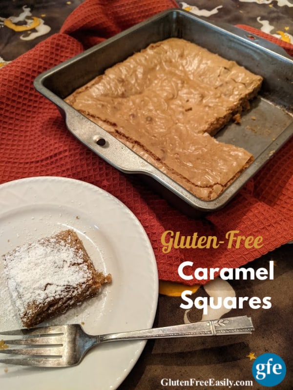 Gluten-Free Caramel Squares in baking dish with two squares missing and one square topped with powdered sugar on a white plate. 