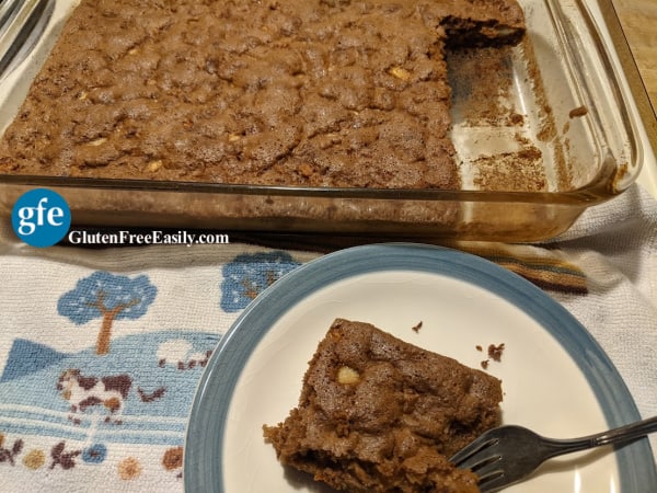 Gluten-Free Apple Cinnamon Cake in glass baking dish after cooling with some slices missing. Grain free and dairy free, too! And no added fat. From glutenfreeeasily.com.