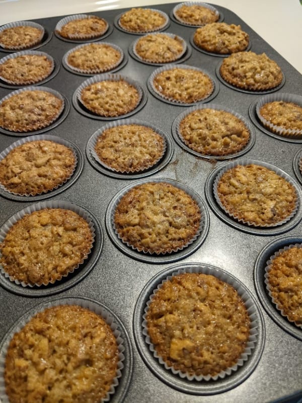 A muffin tin full of gluten-free Pecan Pie Mini Muffins right out of the oven.