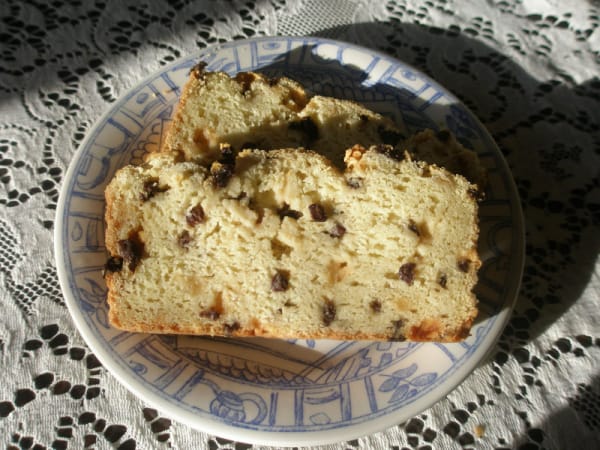 Slices of Gluten-Free Irish Soda Bread from the Art of Gluten-Free Baking on blue patterned plate on white lace tablecloth. One of the Irish Soda Bread recipes featured on gfe.