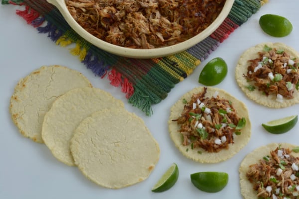 Mexican Pork Carnitas are Mexico’s version of pulled pork. Perfectly seasoned pork that is folded into or piled onto corn tortillas and topped with chopped white onion, fresh cilantro and lime wedges.