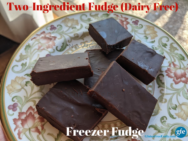 Six pieces of Dairy-Free Two-Ingredient Freezer Fudge piled on a Litchfield china bread and butter plate next to a window.