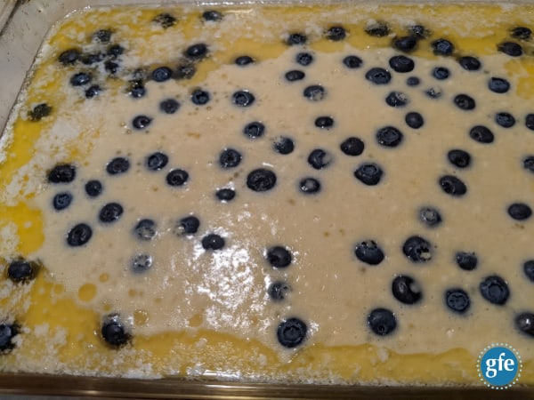 Making Gluten-Free Blueberry Volcano Pancake. Melt butter and evenly spread in baking dish, pour batter over all, drop blueberries evenly over batter, and bake. 