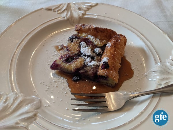 Gluten-Free Blueberry Volcano Pancake right out of the oven. So delicious! I love the corner and edge pieces for that little bit of crusty goodness! p.s. Some of you may call this a Dutch baby, puff pancake, Yorkshire pudding, or another name.