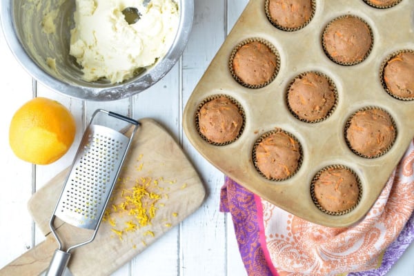 Gluten-Free Carrot Cake Muffins with Cream Cheese Frosting from Nourishing Meals. Honey Cream Cheese Frosting to be exact. Egg free with dairy-free, vegan options. Muffins in pan ready to be frosted.