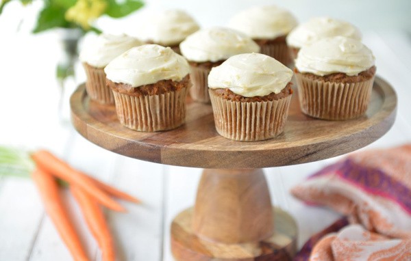 Gluten-Free Carrot Cake Muffins with Cream Cheese Frosting from Nourishing Meals. Honey Cream Cheese Frosting, to be exact. Egg free with dairy-free, vegan options. On wooden cake stand.