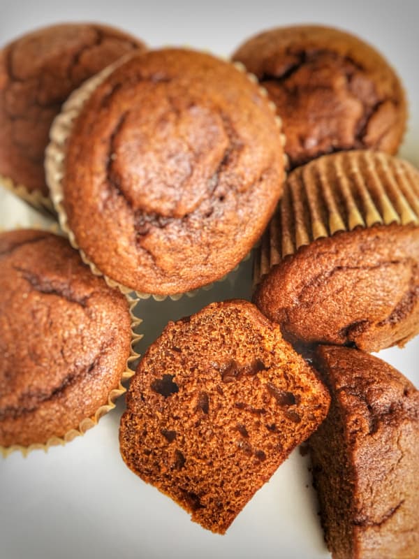Gluten-Free Old-Fashioned Molasses Muffins with one cut in half.