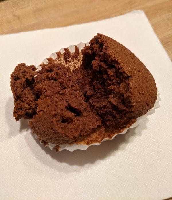 Single Gluten-Free Old-Fashioned Molasses Muffin split in half.