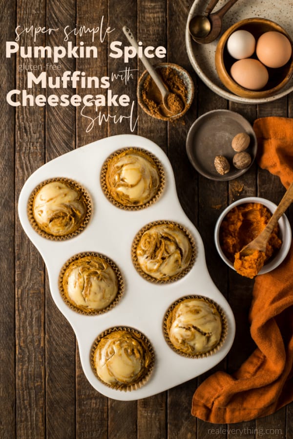 Gluten-Free Pumpkin Spice Muffins with Cheesecake Swirl. Muffins in pan with ingredients beside on wooden table.