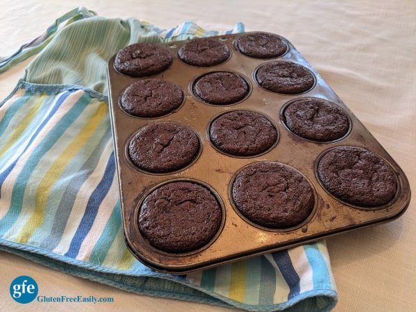 Grain-Free Chocolate Banana Muffins Recipe Cooling on Apron.