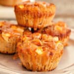 Gluten-free and Paleo Caramel Apple Muffins. Low-carb option. Close-up of muffins on a plate with one stacked on top.