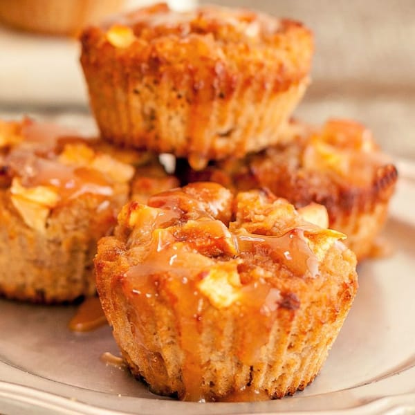 Muffin alle mele caramellate paleo e senza glutine.  Opzione a basso contenuto di carboidrati.  Primo piano dei muffin su un piatto con uno impilato sopra.