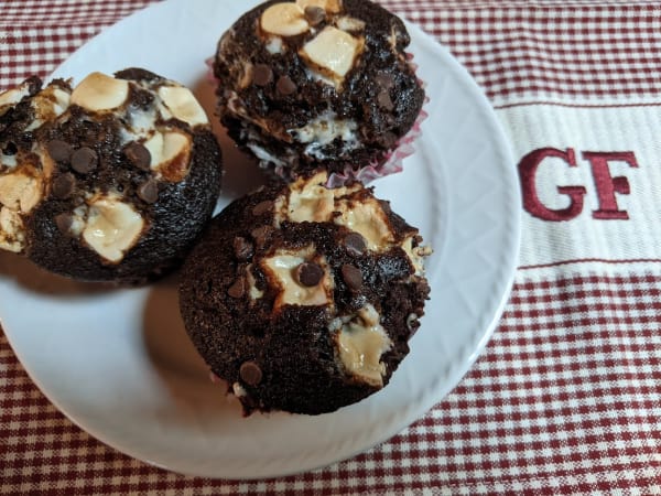 Gluten-Free Gimme S'More Muffins. Three muffins on a textured white plate on top of a GF dish towel.