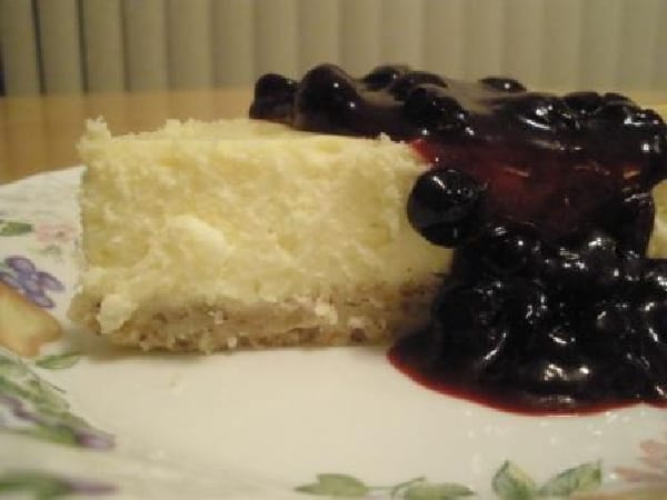 Slice of Gluten-Free Cheesecake with Nut Crust and Optional Blueberry or Huckleberry Topping 