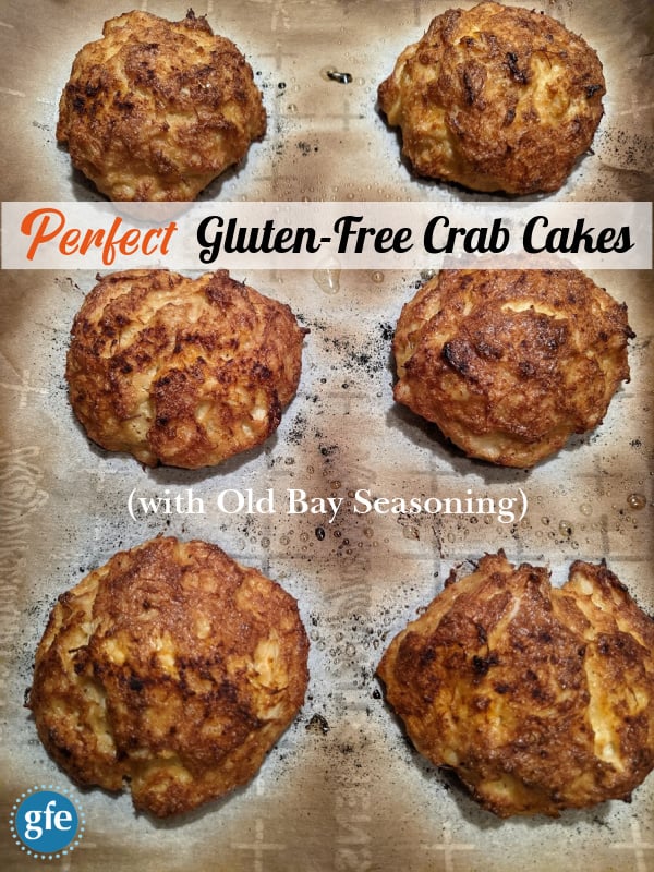 Perfect Gluten-Free Crab Cakes with Old Bay Seasoning. Right out of the oven and ready to enjoy! Six cooked crab cakes on slightly charred, parchment-lined baking sheet.