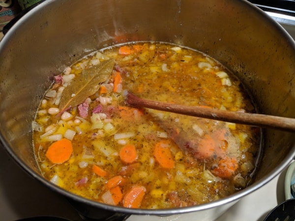 Gluten-Free White Bean and Ham Soup in stockpot on stove.