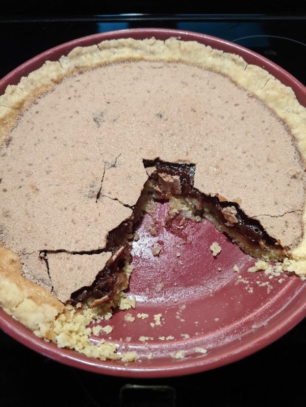Whole Gluten-Free Chocolate Chess Pie with two slices missing.