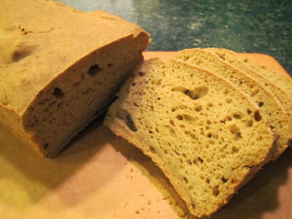 Gluten-Free Sourdough Brown Bread from Successfully Gluten Free. Partially sliced on cutting board.