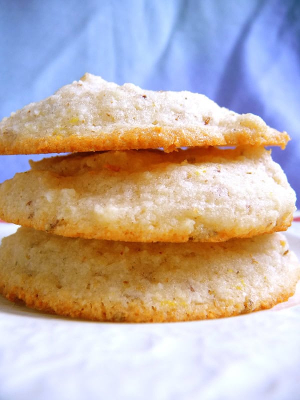 Gluten-Free Cream Cheese Cookies. Not just gluten free but also dairy free, egg free, and vegan. Shown as drop cookies made with granulated white sugar on the left and a stack of piped cookies made with coconut/palm sugar on the right.