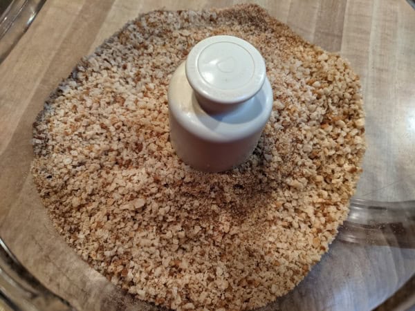 Homemade gluten-free breadcrumbs just made and still in food processor container.