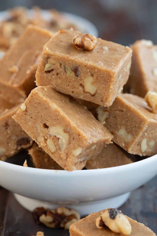 Keto Maple Walnut Fudge stacked in a white bowl. One of a collection of the best gluten-free fudge recipes. Recipes worth gifting for the holidays and beyond!
